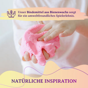 Nahaufnahme von Händen die weichen rosa kinetischen Sand mit Bienenwachs formen